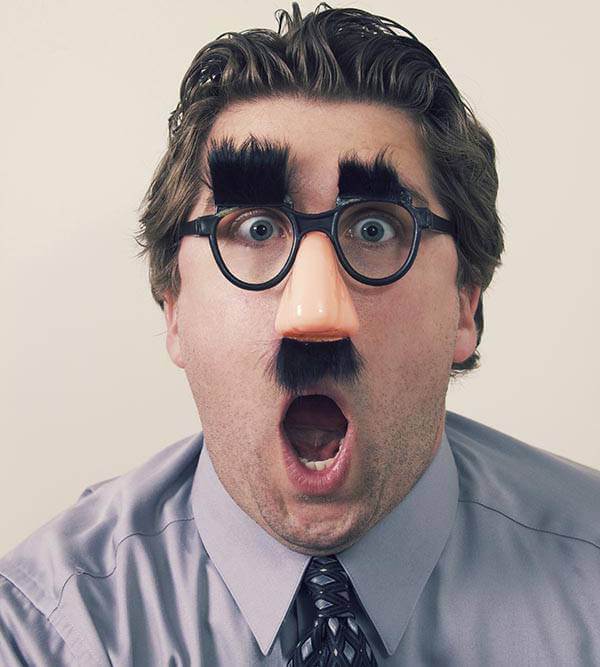 Man wearing funny glasses with heavy eyebrows and mustache.