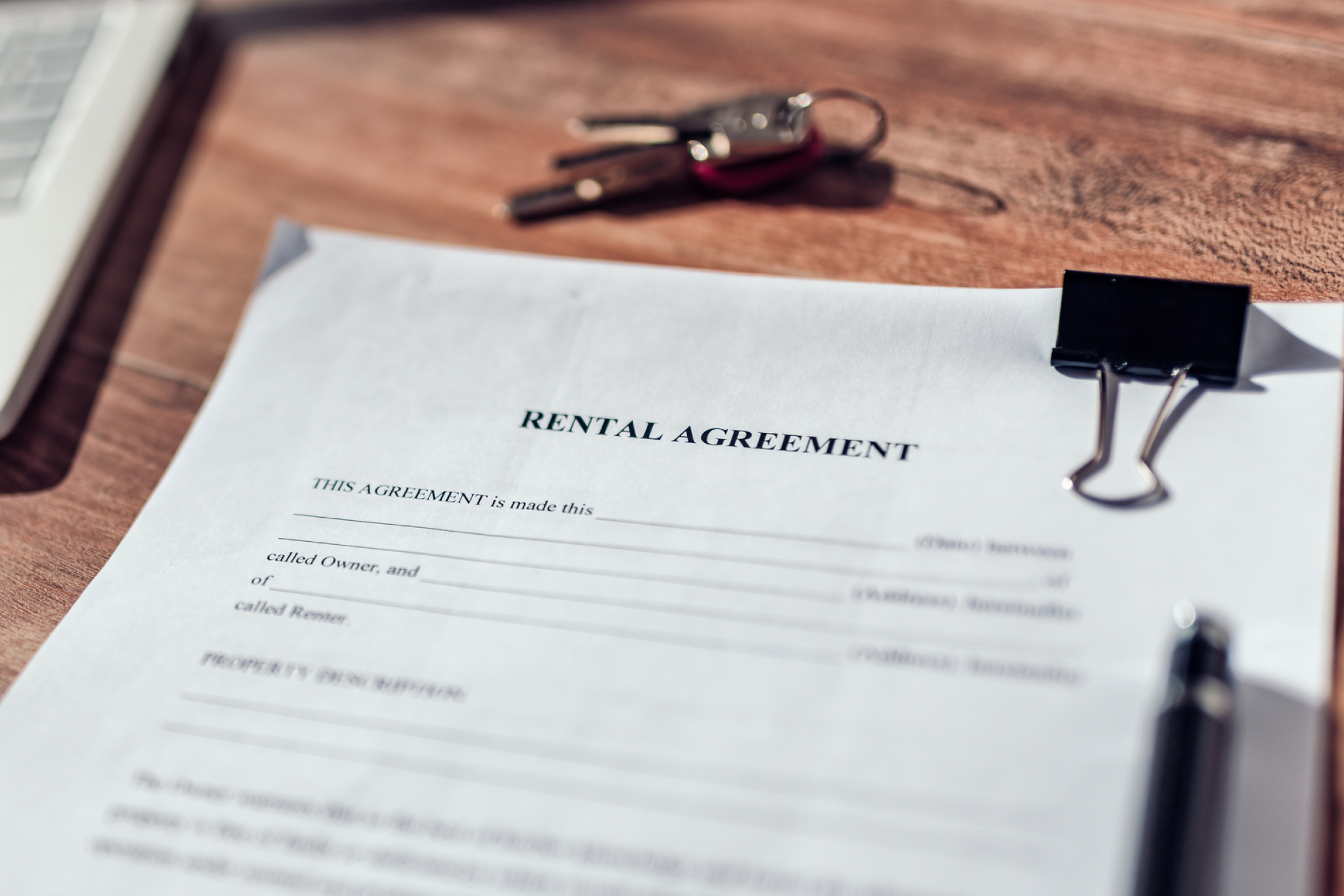 Rental Agreement laying on a desk next to keys
