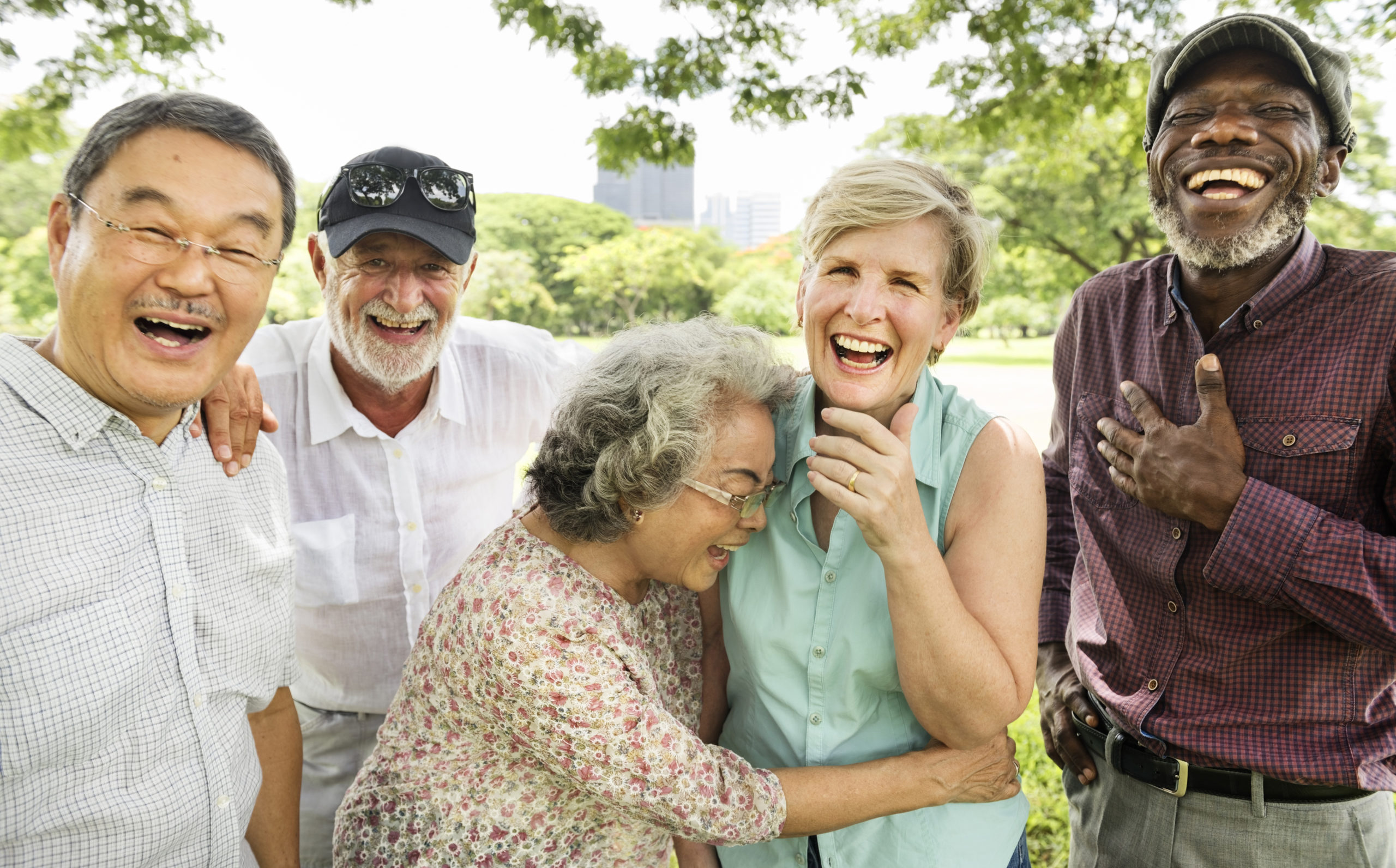 Group of 5 older adults laughing together