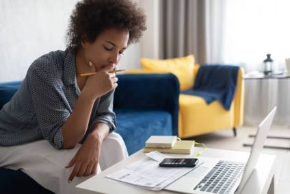 Woman in her living room working on an amended tax return.