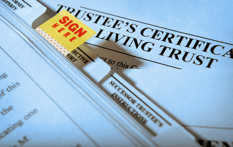 Trustee's Certificate Living Trust documents with a Sign Here sticker.