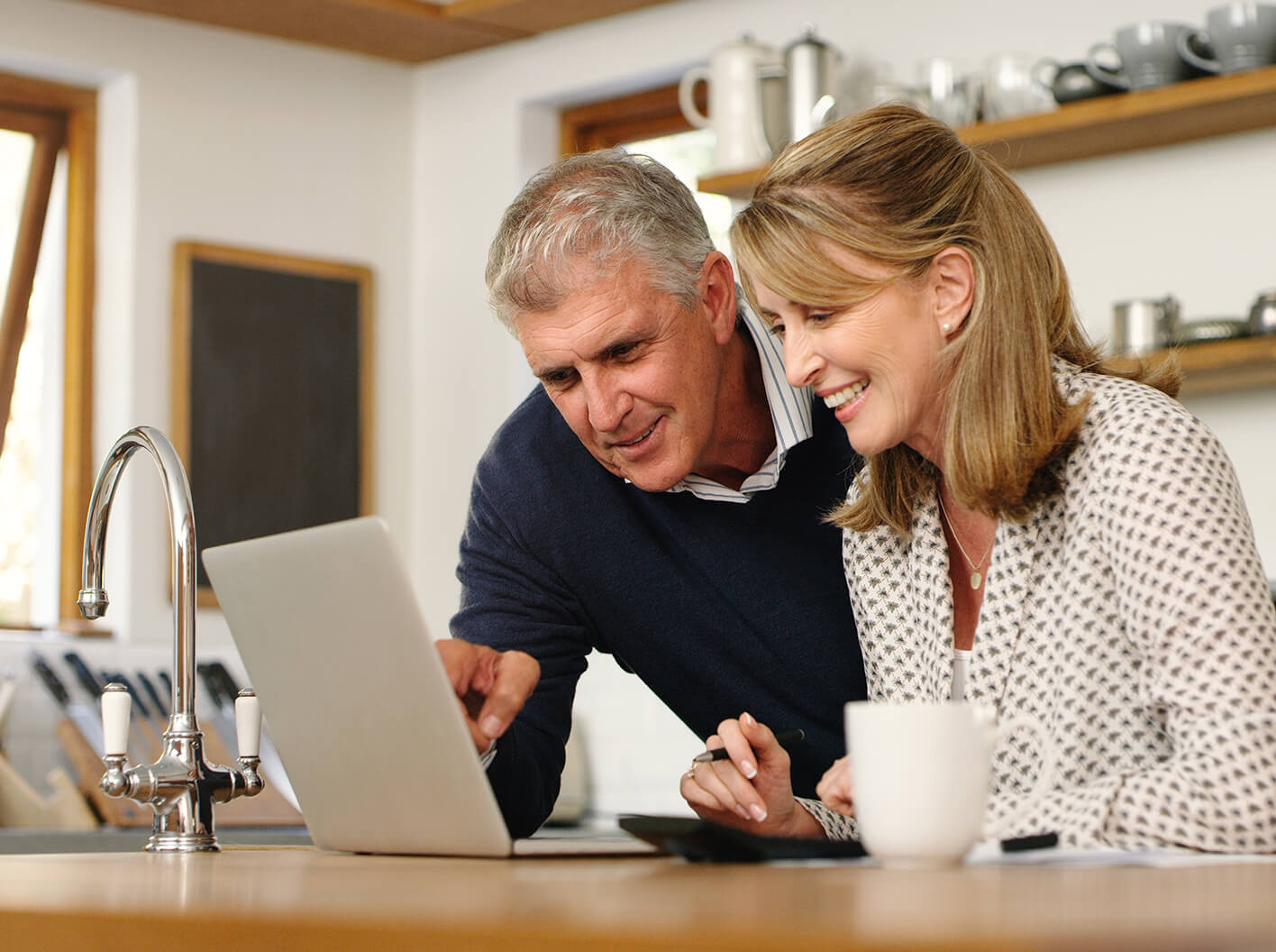 Couple doing their estate planning on a laptop computer.